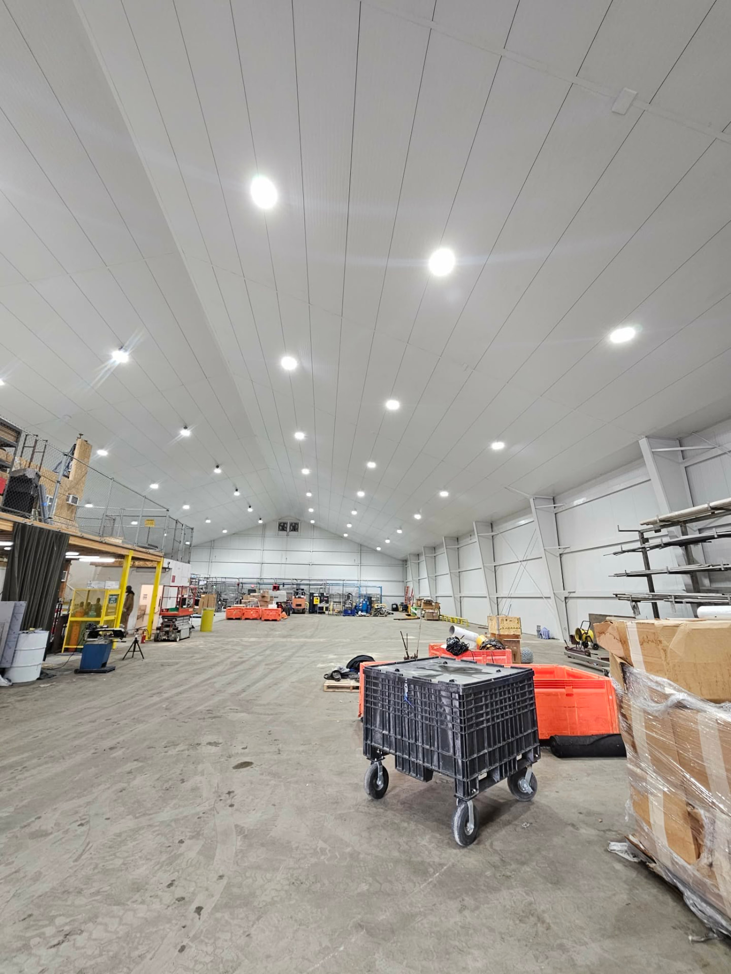 Finished white metal ceiling liner panels spanning the interior of a commercial building